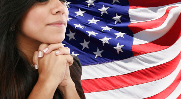 woman praying, American flag