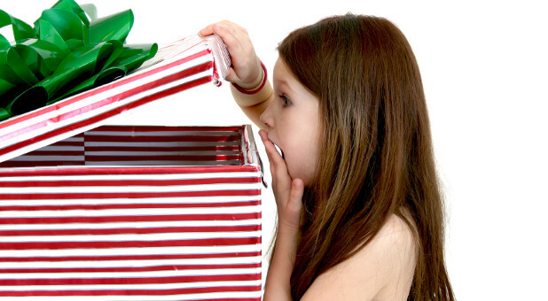 girl looking in a big wrapped present
