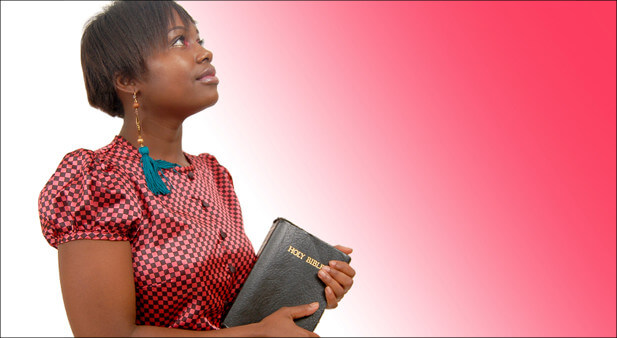 woman holding Bible looking up