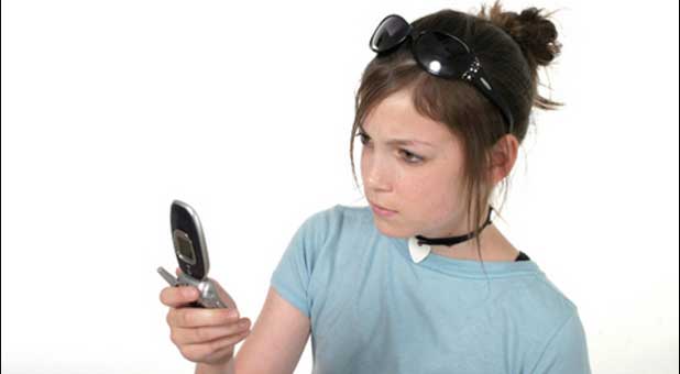 teen with cell phone