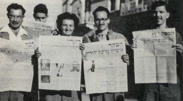 Zippy (Borowsky) Porath and other American students in Jerusalem holding newspapers (Nov. 30, 1947) announcing the UN vote on the Partition Plan for Palestine, approving a Jewish State