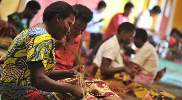 African woman making baskets