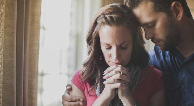 Husband and wife praying together