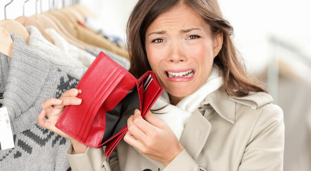 woman crying over empty wallet