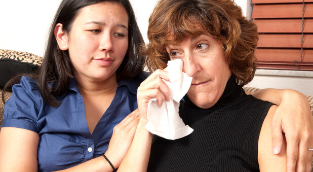 woman comforting crying woman