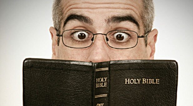 crazy man holding bible