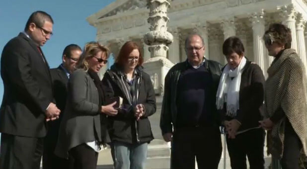 Shield representatives, including Charisma editor Jennifer LeClaire (center), pray outside the Supreme Court.