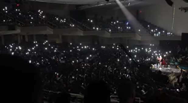 Phones light up all over the sanctuary, indicating people who made a faith commitment.