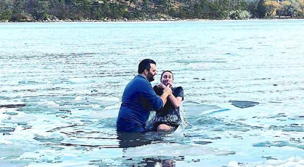 West Point campus minister Joshua Austin (L) baptized Brooke Parker (R) in the icy Hudson River.