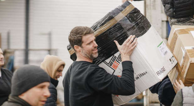 Michael Evans helps unload food and supplies to assist the people in war-torn Ukraine.